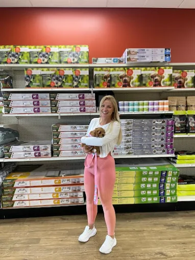 A customer holding a puppy inside Petland